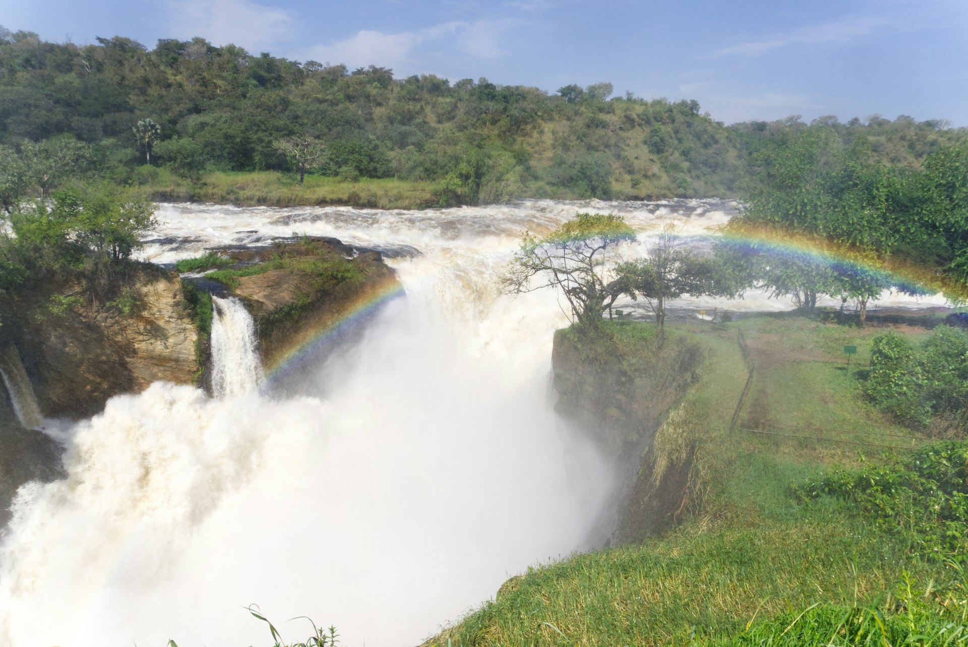 a waterfall with a rainbow in the middle of it