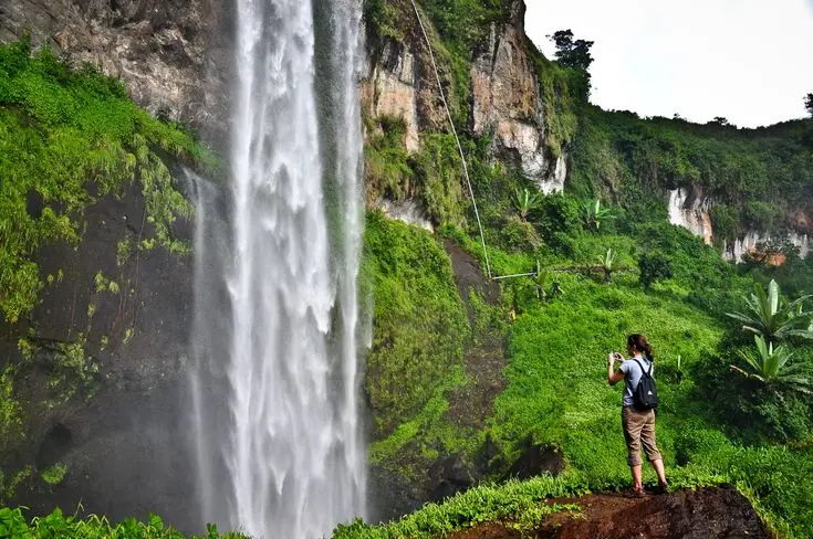 A tourists viewing Sipi Falls in Uganda
