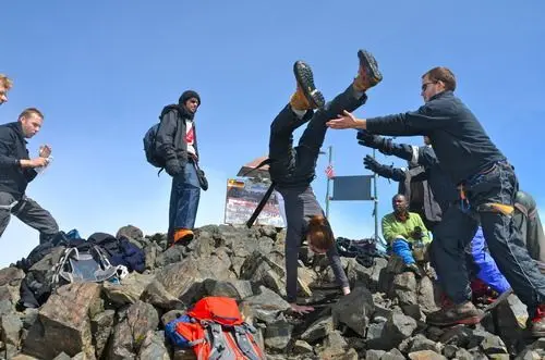 Tourists jubilate reaching the Mountain peak