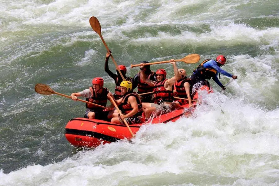 White water rafting in Jinja, Uganda tourists enjoying adrenaline white water rafting
